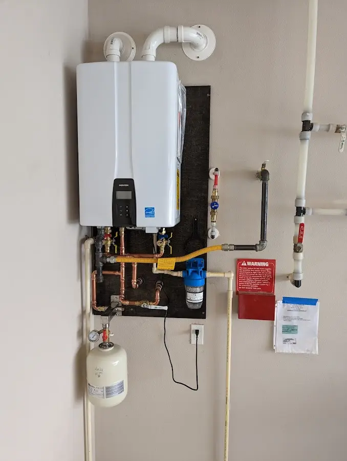 Professional plumber installing copper piping in a Slatington home